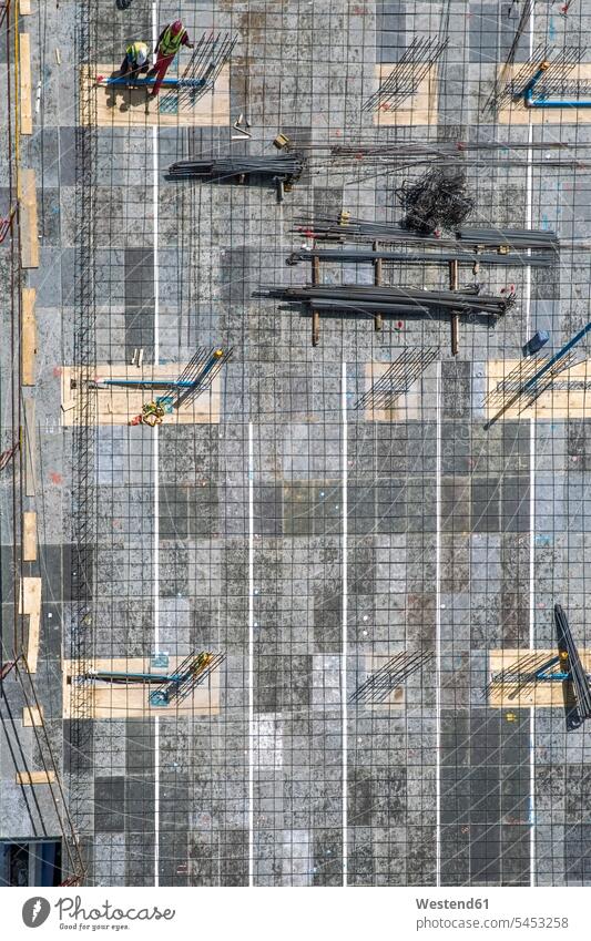 Two workers on construction site, top view Architecture ferroconcrete building construction economic growth accretion increase boom economic upturn