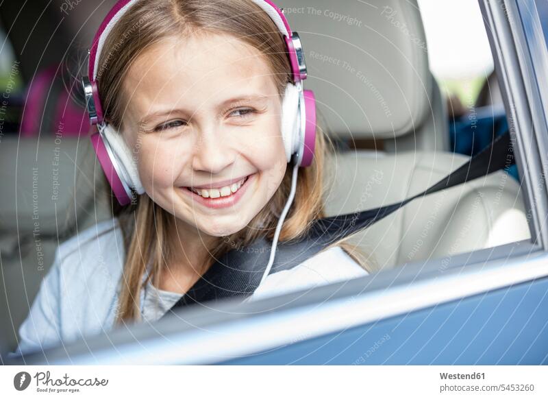 Girl sitting in car, looking out of window, listening music Seated automobile Auto cars motorcars Automobiles Looking Through Window Looking Through A Window