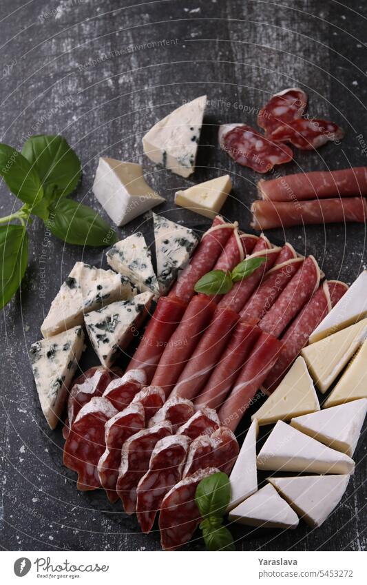 photo of sliced pieces of several types of sausage and cheese, photography meat salami variation snack no people food slice of food horizontal freshness rustic
