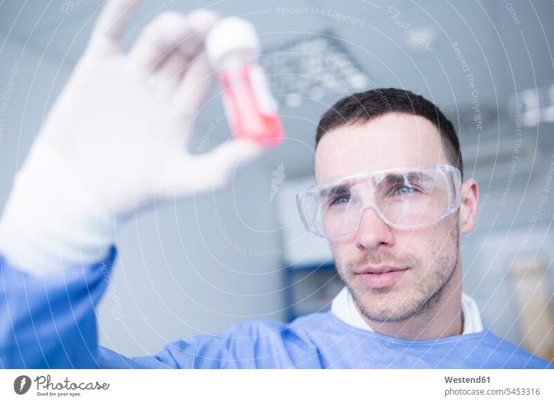 Scientist in lab examining sample laboratory swatch Swatches Samples checking examine looking view seeing viewing scientist workplace work place place of work