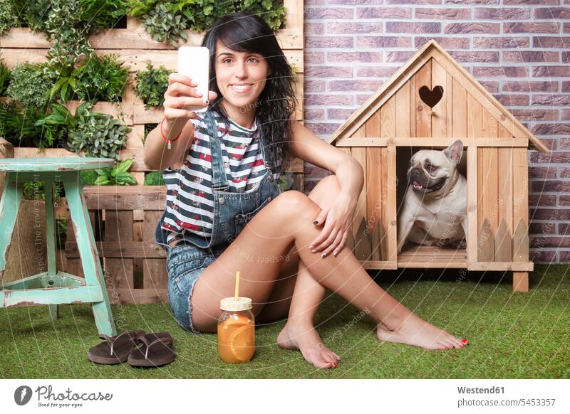 Woman and french bulldog taking a selfie on the terrace dogs Canine smiling smile sitting Seated Selfie Selfies dog kennel dog house doghouse mobile phone