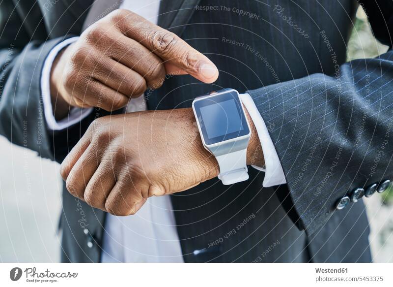 Mature businessman wearing smartwatch Time checking smart watch computer computers wearable wearable computers wearables Businessman Business man Businessmen
