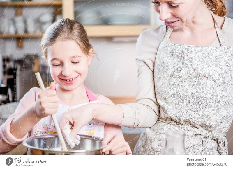Mother and daughter baking in kitchen together bake smiling smile domestic kitchen kitchens daughters mother mommy mothers ma mummy mama child children family