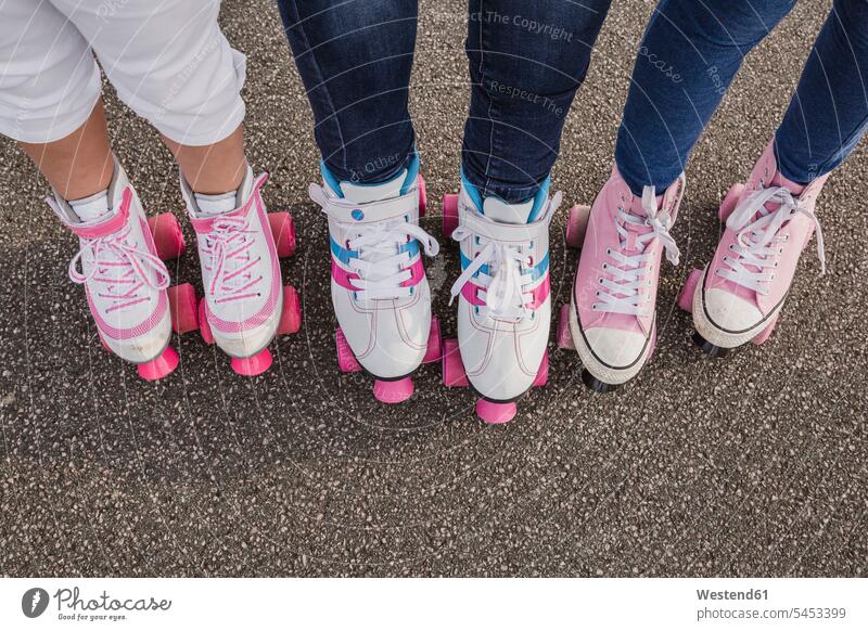 Mother and her two daughters on roller skates, partial view girl females girls Roller-Skate child children kid kids people persons human being humans