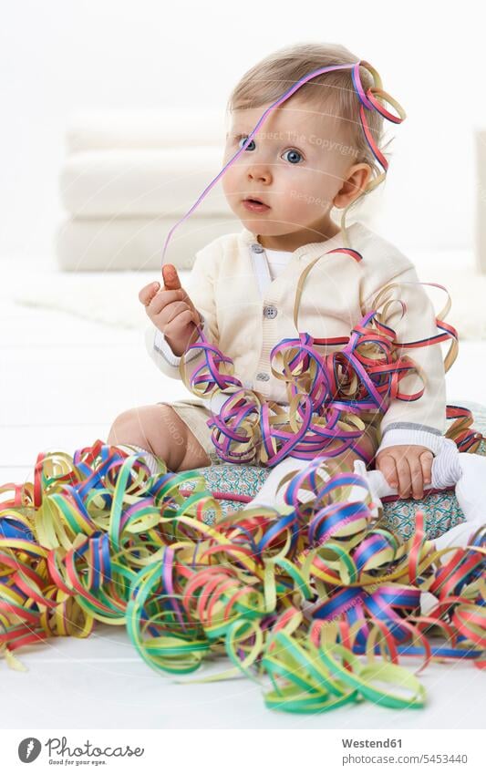 Portrait of toddler playing with streamers blow-out baby boys male infants nurselings babies portrait portraits people persons human being humans human beings