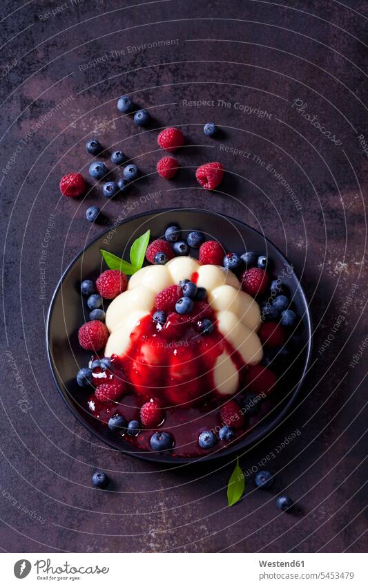 Custard with raspberries, blueberries and raspberry sauce on plate Plate dish dishes Plates sweet Sugary sweets prepared garnished ready to eat ready-to-eat