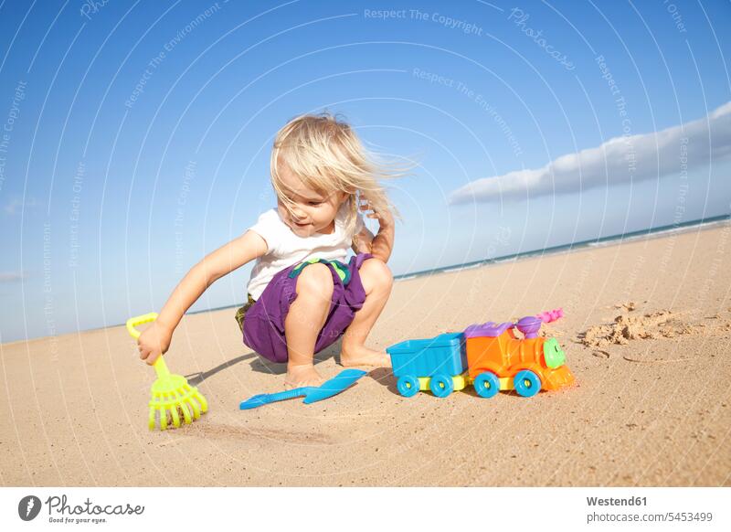 Spain, Fuerteventura, girl playing on the beach females girls beaches happiness happy child children kid kids people persons human being humans human beings
