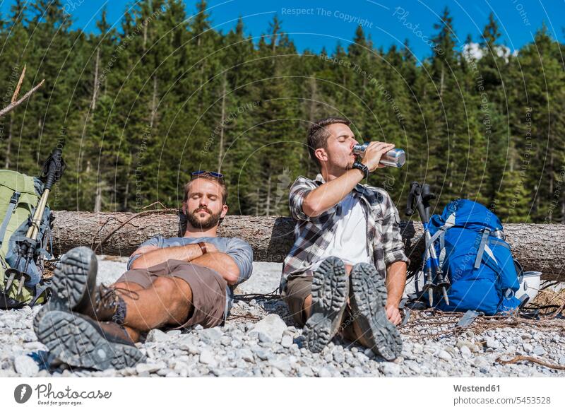 Germany, Bavaria, two hikers having a rest friends portrait portraits friendship enjoying indulgence enjoyment savoring indulging recovering wanderers resting