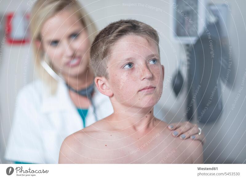 Female pedeatrician examining boy's lungs with stethoscope Auscultation auscultate auscultating boys males pediatrician paediatricians child children kid kids