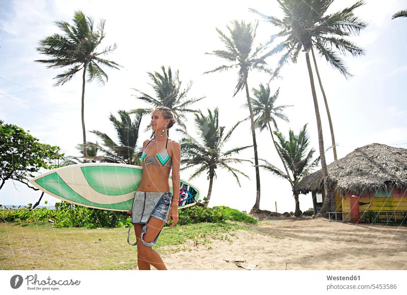 Woman at the coast with surfboard walking going surfing surf ride surf riding Surfboarding beach beaches surfboards woman females women water sports Water Sport