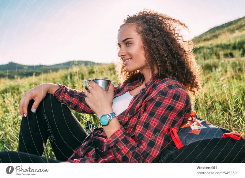 Teenage girl with thermos flask having a rest in nature portrait portraits Teenage Girls female teenagers Teenager Teens people persons human being humans