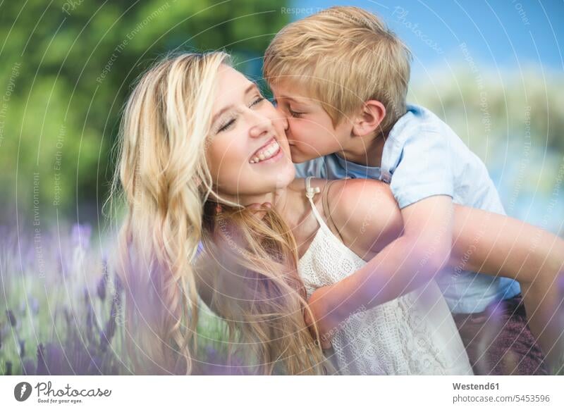Happy mother with son in lavender field sons manchild manchildren smiling smile mommy mothers mummy mama family families people persons human being humans