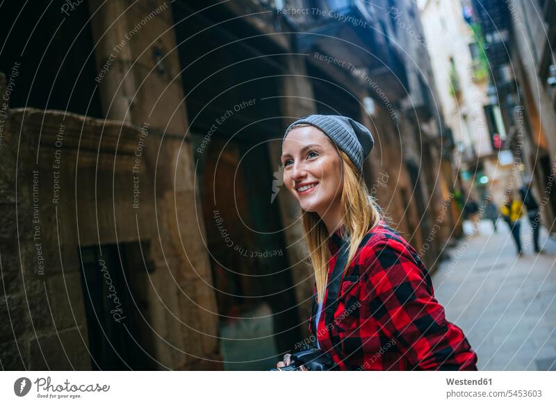 Spain, Barcelona, portait of smiling young woman with camera at Gothic Quarter females women female tourist portrait portraits Adults grown-ups grownups adult