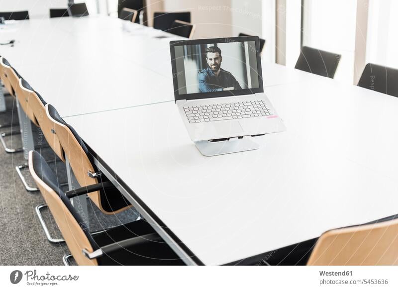 Man's image on laptop display in conference room images picture pictures Video Conference video conferencing man men males Laptop Computers laptops notebook