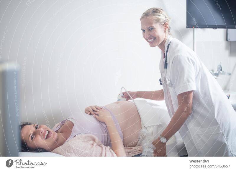 Doctor in hospital doing sonogram with pregnant woman Ultrasonography Pregnant Woman pregnancy Gestation Medical Clinic examining checking examine doctor