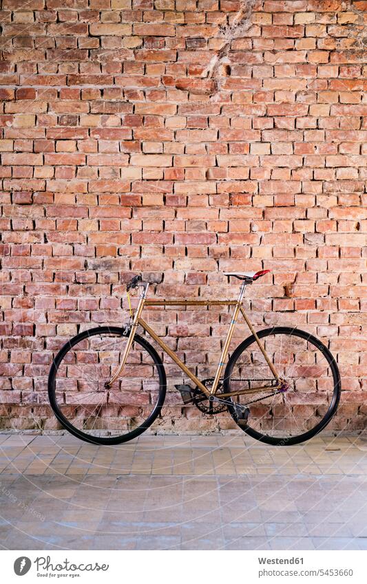Bicycle at brick wall in office offices office room office rooms bicycle bikes bicycles workplace work place place of work brick walls copy space business