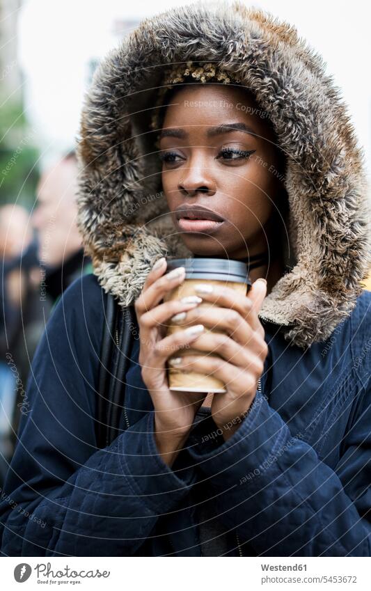 Portrait of fashionable young woman with coffee to go wearing hooded jacket Coffee to Go takeaway coffee females women Hooded Jackets portrait portraits