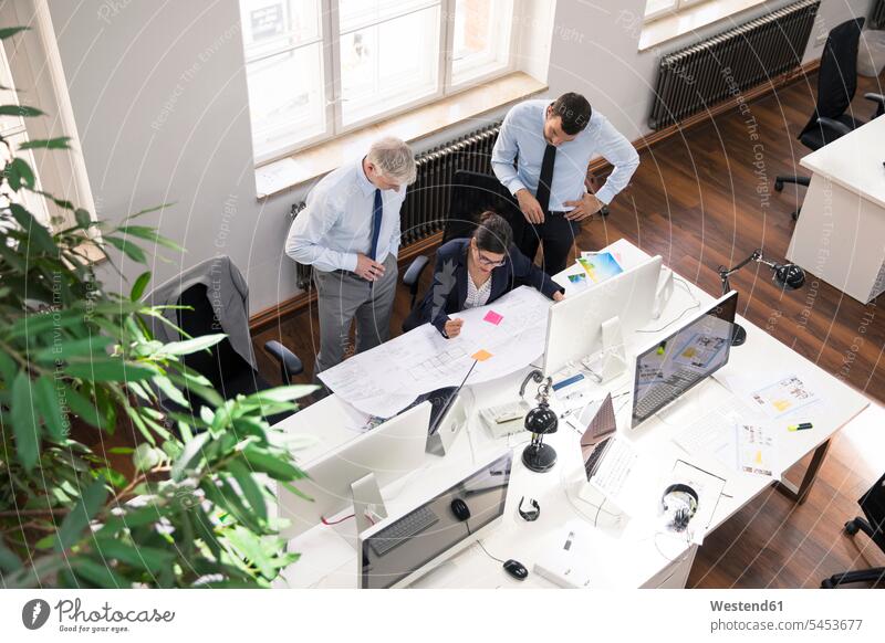 Team of business people in planning office working on blue print offices office room office rooms At Work Planning planned floor plan floor plans ground plan