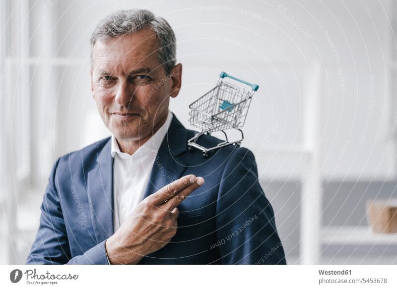 Portrait of manager with mini shopping cart Businessman Business man Businessmen Business men business people businesspeople business world business life