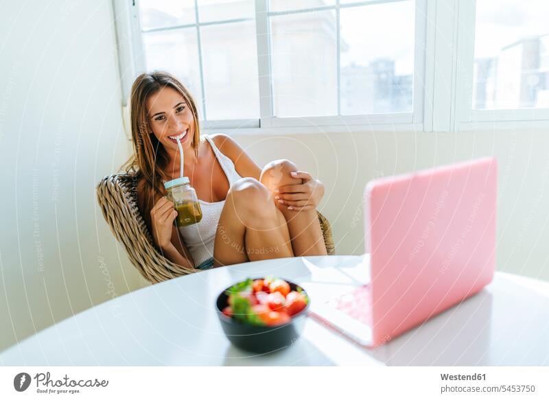 Portrait of smiling young woman relaxing at home females women portrait portraits Adults grown-ups grownups adult people persons human being humans human beings