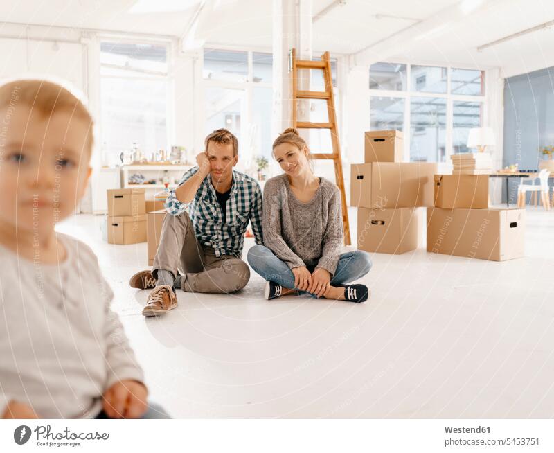 Smiling couple with little daughter moving into new home twosomes partnership couples smiling smile daughters move in moving house Moving Home at home family