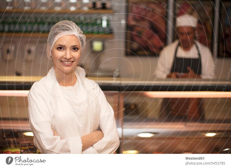 Portrait of smiling woman in butchery charcuterie shop working At Work smile shop assistant shop assistants portrait portraits retail trade trading
