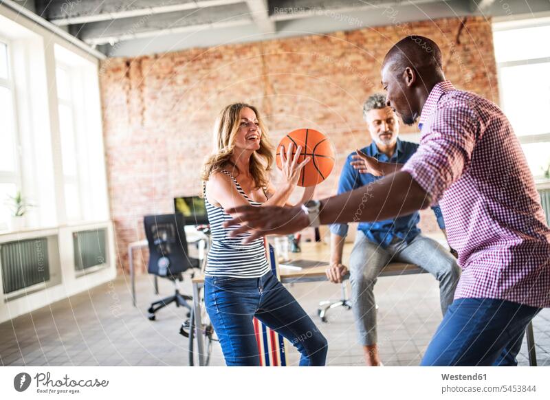 Colleagues playing basketball in office Basketball offices office room office rooms colleagues sport sports workplace work place place of work hobby hobbies