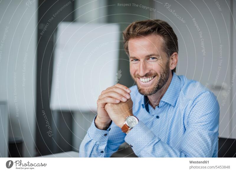 Portrait of laughing businessman in the office Businessman Business man Businessmen Business men portrait portraits business people businesspeople