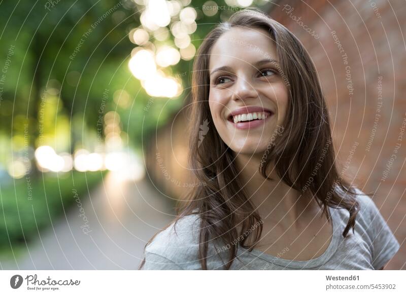 Portrait of happy young woman outdoors smiling smile females women portrait portraits Adults grown-ups grownups adult people persons human being humans
