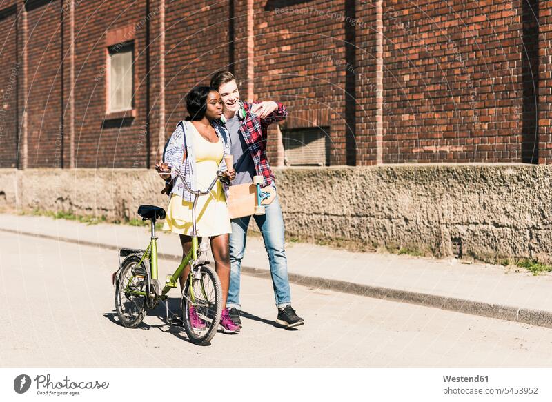 Young couple with bicycle and skateboard taking smartphone selfies Smartphone iPhone Smartphones Selfie Selfies mobile phone mobiles mobile phones Cellphone