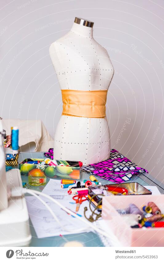 Fashion designer's working table with mannequin and equipment nobody fabric fabrics cloth Dressmaker's Model dressmakers model tailor's dummy fashion