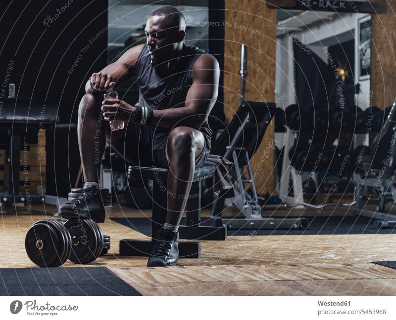 Athlete in gym relaxing after training muscular muscles athletic weight weights gyms Health Club athlete Sportspeople Sportsman Sportsperson athletes Sportsmen
