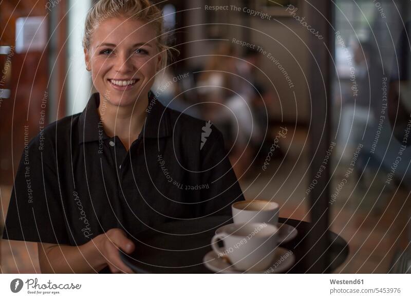 Portrait of smiling waitress in cafe waitresses portrait portraits waiter server waiters service Wait Staff occupation profession professional occupation jobs