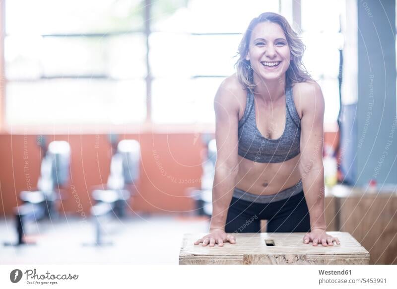 Portrait of happy young woman in gym gyms Health Club smiling smile exercising exercise training practising females women fitness sport sports Adults grown-ups