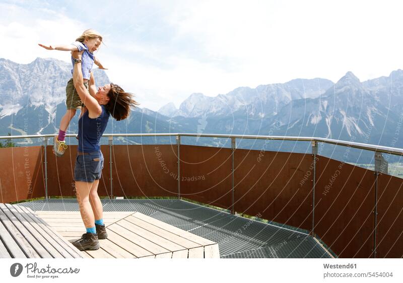 Austria, South Tyrol, mother lifting up her daughter twisting Twist lift up observation point viewpoint lookout point Joy enjoyment pleasure Pleasant delight