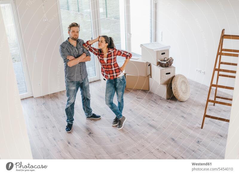 Couple standing in their new home owner owners property flat flats apartment apartments moving house move Moving Home couple twosomes partnership couples people