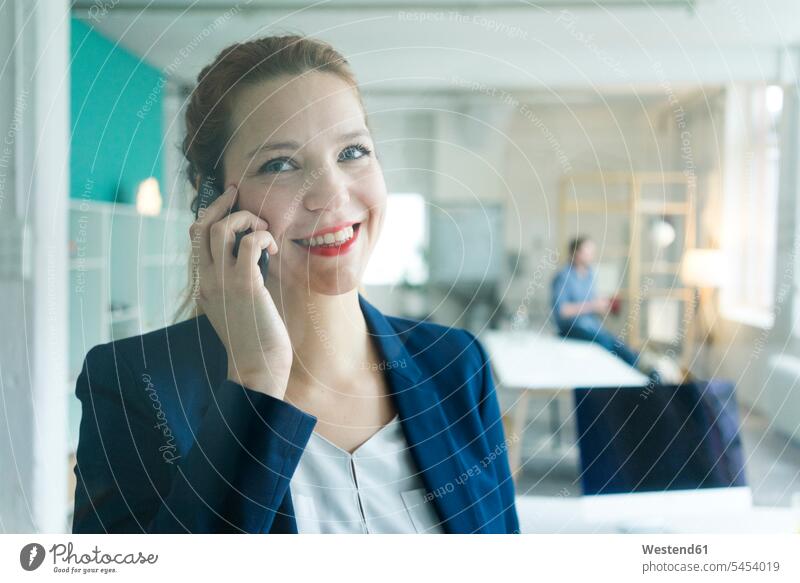 Smiling businesswoman talking on the phone happiness happy call telephoning On The Telephone calling mobile phone mobiles mobile phones Cellphone cell phone