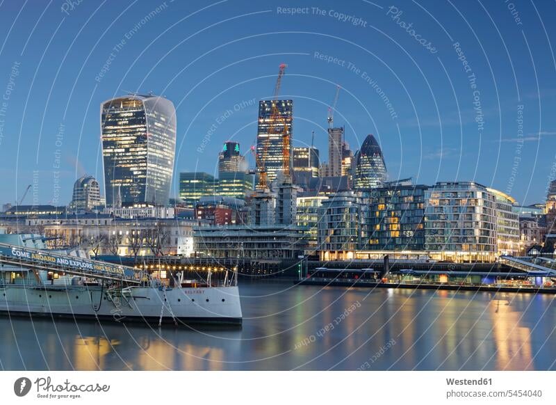 UK, London, skyline with office towers and HMS Belfast museum ship at dusk View Vista Look-Out outlook urban scene Architecture city cities metropolis