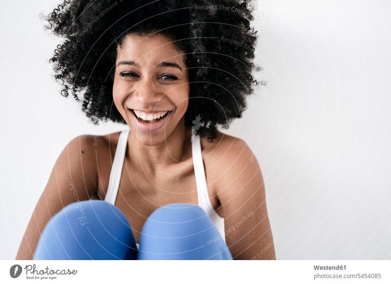 Portrait of a happy young woman, laughing females women sitting Seated fit training Sport Training Adults grown-ups grownups adult people persons human being