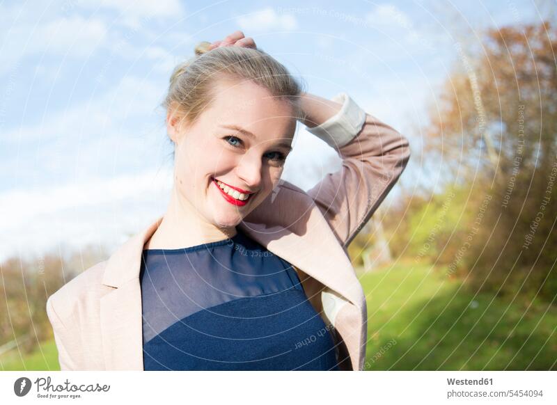 Portrait of smiling young blond woman outdoors smile females women portrait portraits Adults grown-ups grownups adult people persons human being humans