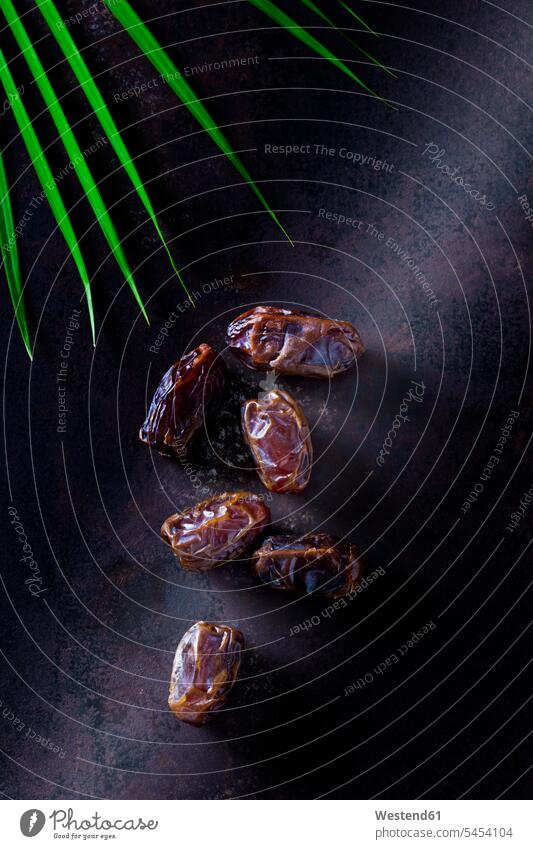 Dates on rusty metal food and drink Nutrition Alimentation Food and Drinks copy space Brown Background brown shadow shadows Shades gleaming close-up close up