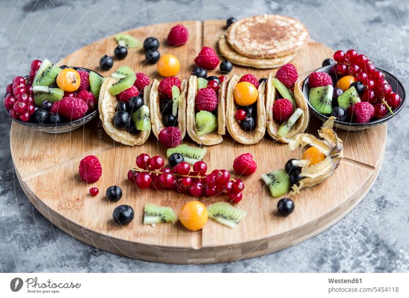 Taco Pancakes with fruits nobody rich in vitamines garnished ready to eat ready-to-eat Physalis Cape gooseberry Physalis peruviana Cape gooseberries blueberry