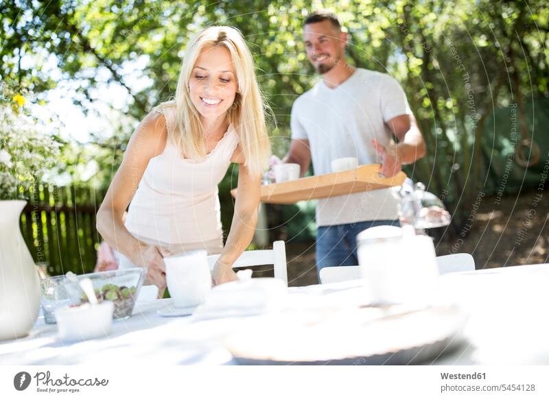 Smiling couple laying garden table - a Royalty Free Stock Photo from ...