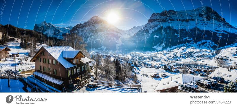 Switzerland, Canton of Bern, Grindelwald, townscape in winter at sunrise with Maettenberg, Mittelhorn and Wetterhorn morning in the morning Bernese Oberland