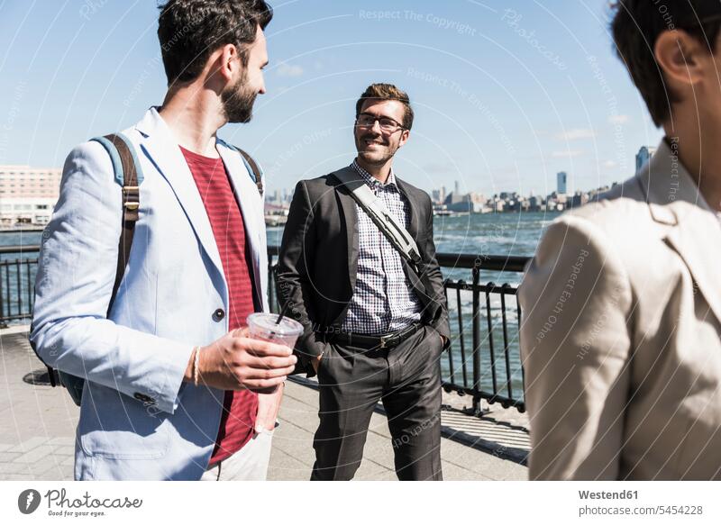 USA, colleagues walking at New Jersey waterfront Businessman Business man Businessmen Business men going smiling smile business people businesspeople