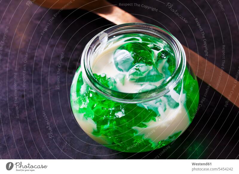 Green woodruff jelly in a glass with vanilla sauce Jelly Jello ready to eat ready-to-eat close-up close up closeups close ups close-ups Galium odoratum Glass