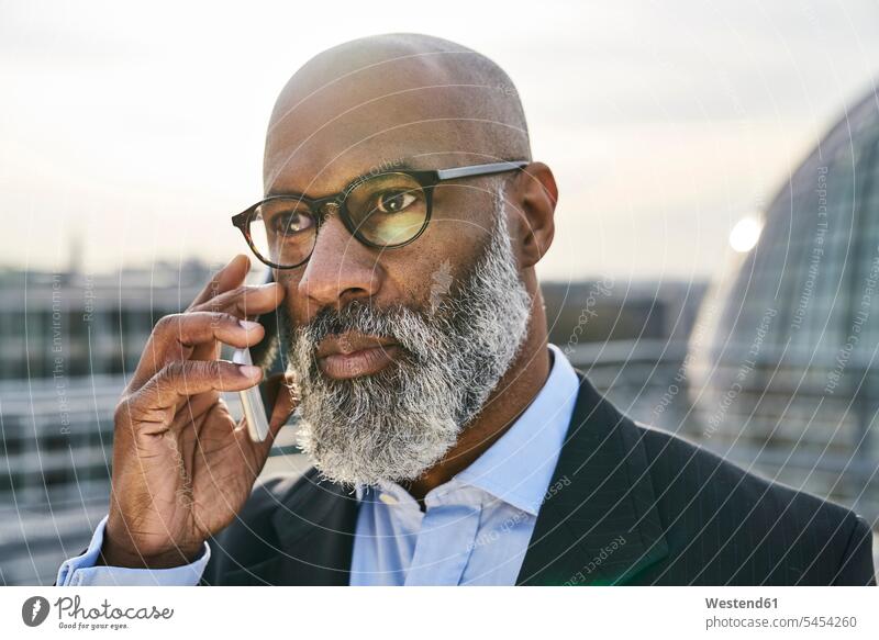 Businessman on the phone, looking worried call telephoning On The Telephone calling Business man Businessmen Business men mobile phone mobiles mobile phones