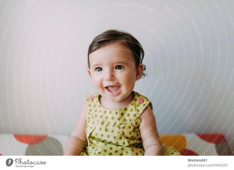 Portrait of happy baby girl wearing a dress portrait portraits infants nurselings babies laughing Laughter people persons human being humans human beings