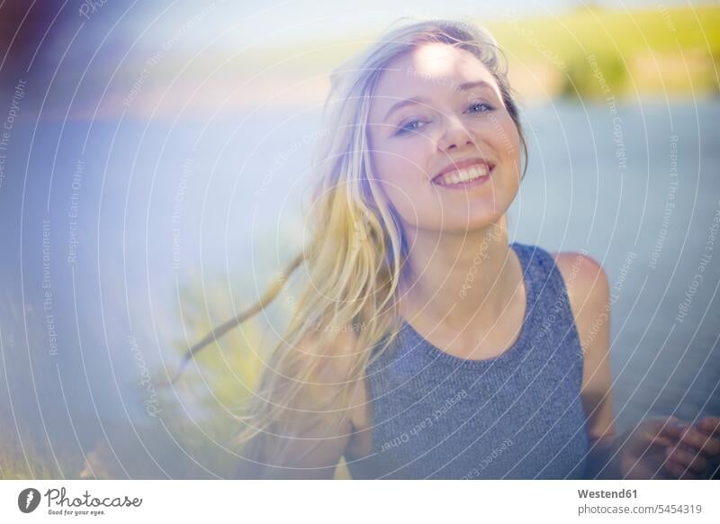 Portrait of smiling young woman outdoors relaxed relaxation smile females women relaxing Adults grown-ups grownups adult people persons human being humans