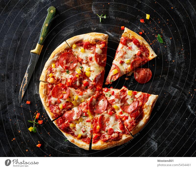 Sliced pizza with salami on dark ground food and drink Nutrition Alimentation Food and Drinks Red Bell Pepper red pepper Red Bell Peppers homemade home made
